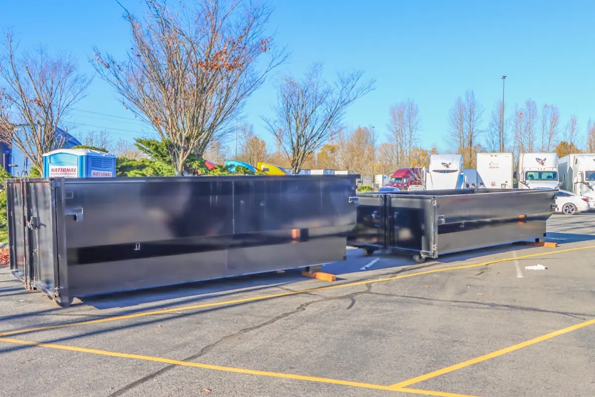 Professional dumpster rental service with roll-off container on residential driveway in Choctaw